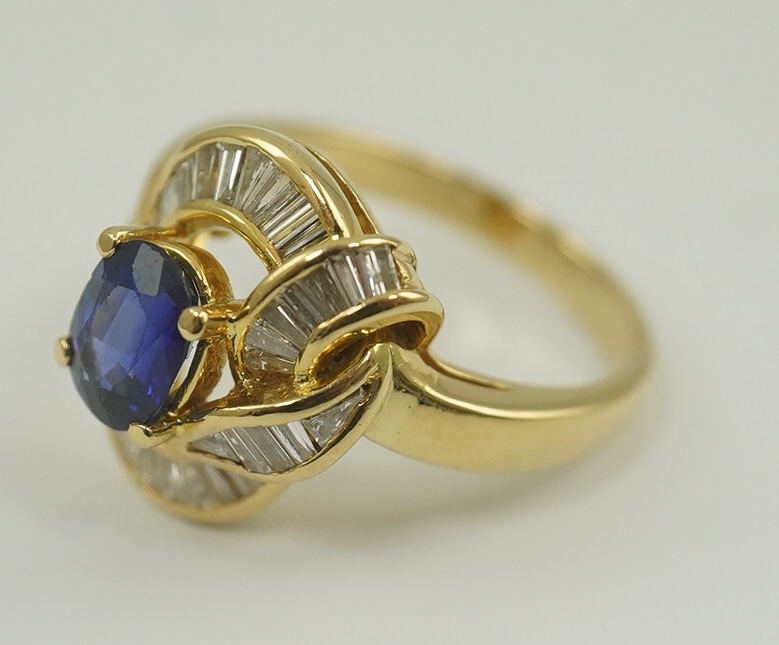 A modern 18k gold, sapphire and diamond cluster set dress ring